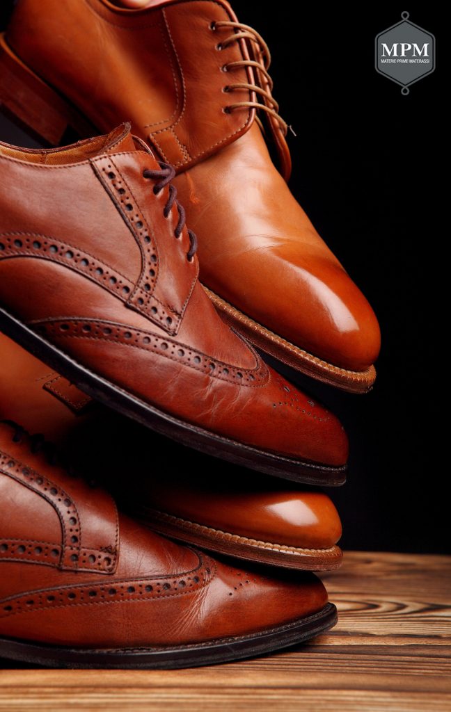 Four toes one on one of brown shoes brogues and derby on the wooden table.Shoes shine concept of luxury shoes